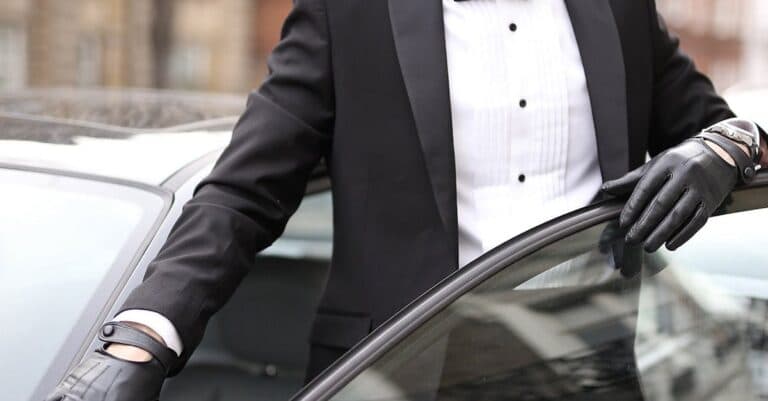 Places & Attractions Blogs | Articles | News | Tips & Tricks | Video | FAQ | Information | Infograph. 19 Well-dressed man in a tuxedo standing confidently by his car in an urban setting.