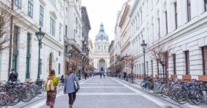 Pedestrian street leading to St. Stephen's Basilica in Budapest, featuring urban architecture.