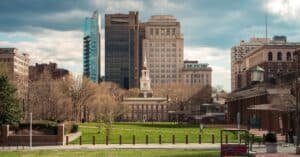 Scenic view of Independence Hall with modern Philadelphia skyline in the background.