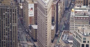 Aerial view of the iconic Flatiron Building in bustling New York City.