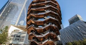 The Vessel and modern skyscrapers in Hudson Yards, a vibrant New York City attraction.