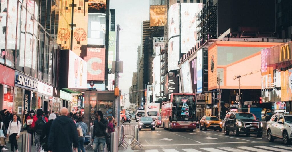 Busy Times Square in NYC, bustling with people, billboards, and traffic.