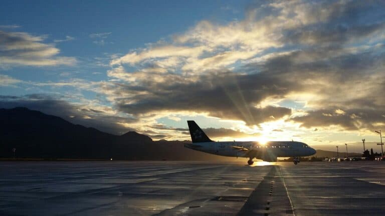 New York Blogs | Articles | News | Tips & Tricks | Video | FAQ | Information | Infograph. 35 A beautiful silhouette of an airplane on a runway during a vibrant sunset at Čilipi Airport, Croatia.