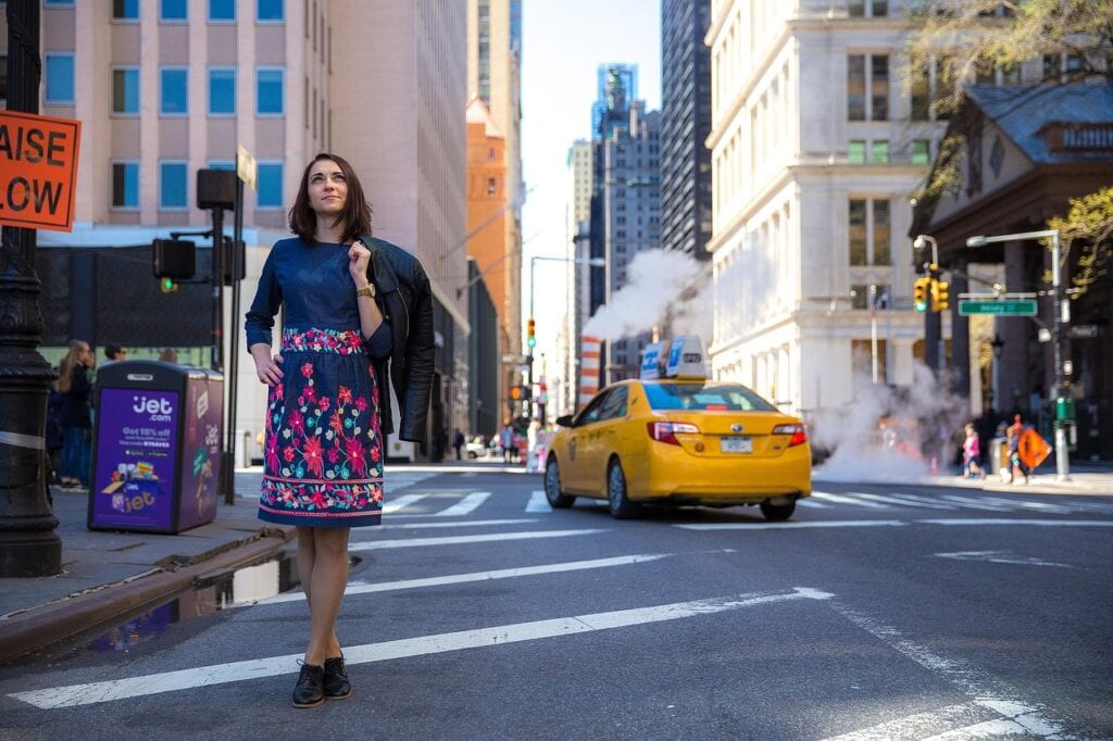 Side-by-side comparison illustrating the difference when figuring out how much is a flat rate taxi to JFK versus a smooth premium transfer