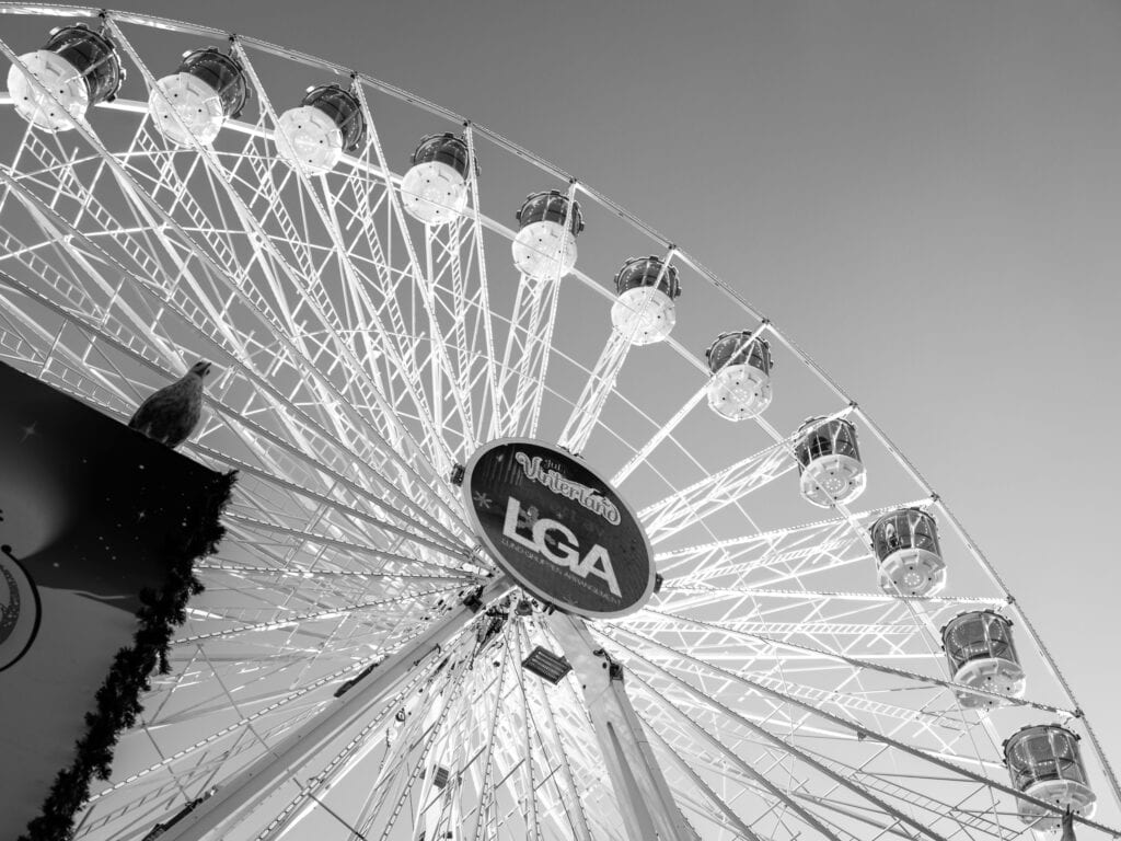 Low angle view of a majestic Ferris wheel, Oslo, in monochrome, highlighting its intricate structure.