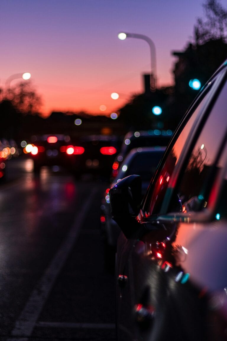 A Dial7 driver in a TLC-licensed sedan helps a business traveler with a briefcase at LaGuardia’s arrivals, offering an affordable car service to LaGuardia under the glow of Queens’ 2025 terminal lights.