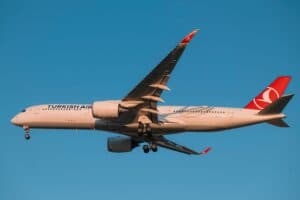 Turkish Airlines Airbus A350 captured mid-flight with a clear blue sky.