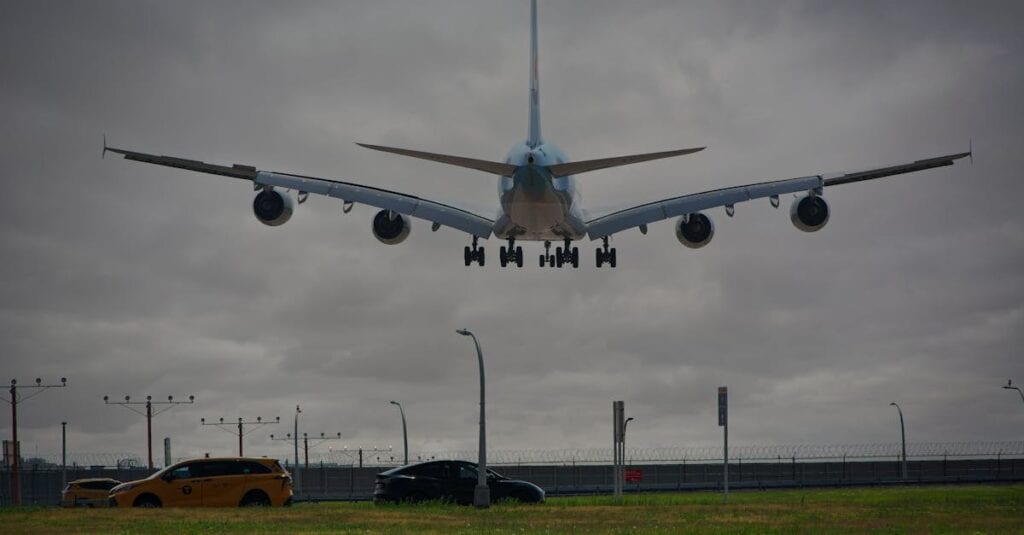 A passenger airplane lands at New York airport with cloudy skies, showcasing aviation and urban transport.