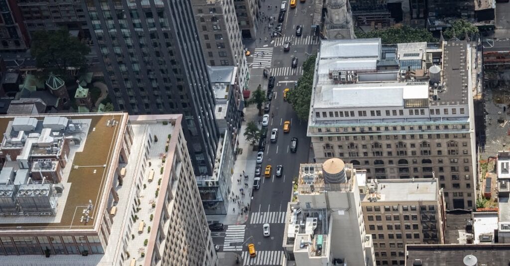Aerial shot of New York City's buildings and busy street with yellow cabs.