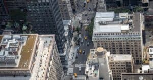Aerial shot of New York City's buildings and busy street with yellow cabs.