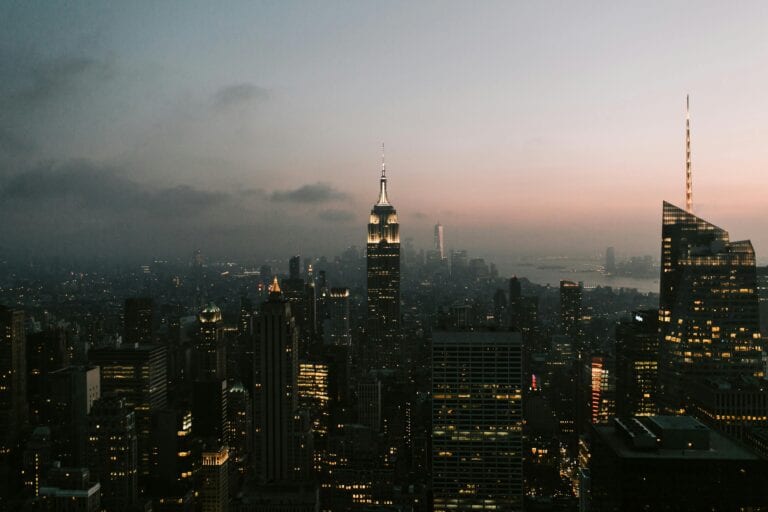Twilight view of New York City skyline featuring the iconic Empire State Building.