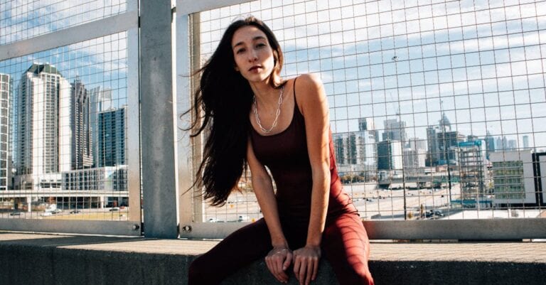 Stylish urban portrait of a woman against Atlanta's modern skyline.