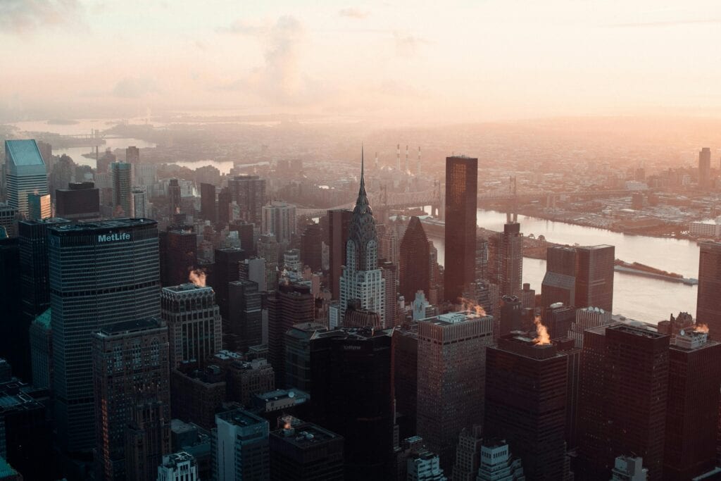 Aerial view of New York City's skyline at dawn featuring the Chrysler Building.