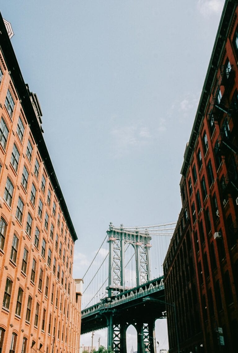 Manhattan Bridge framed by urban architecture in New York City, showcasing classic urban design.