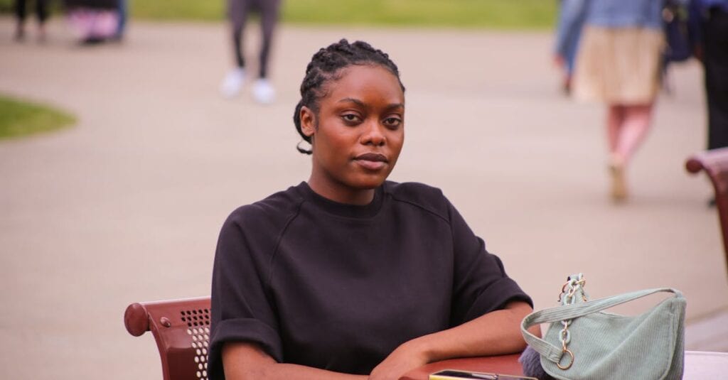A young woman enjoying a peaceful moment at an outdoor café in Albany, New York.