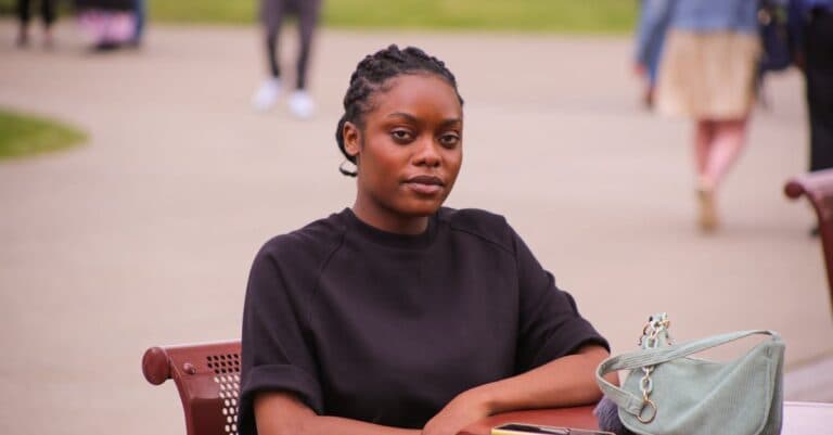 A young woman enjoying a peaceful moment at an outdoor café in Albany, New York.