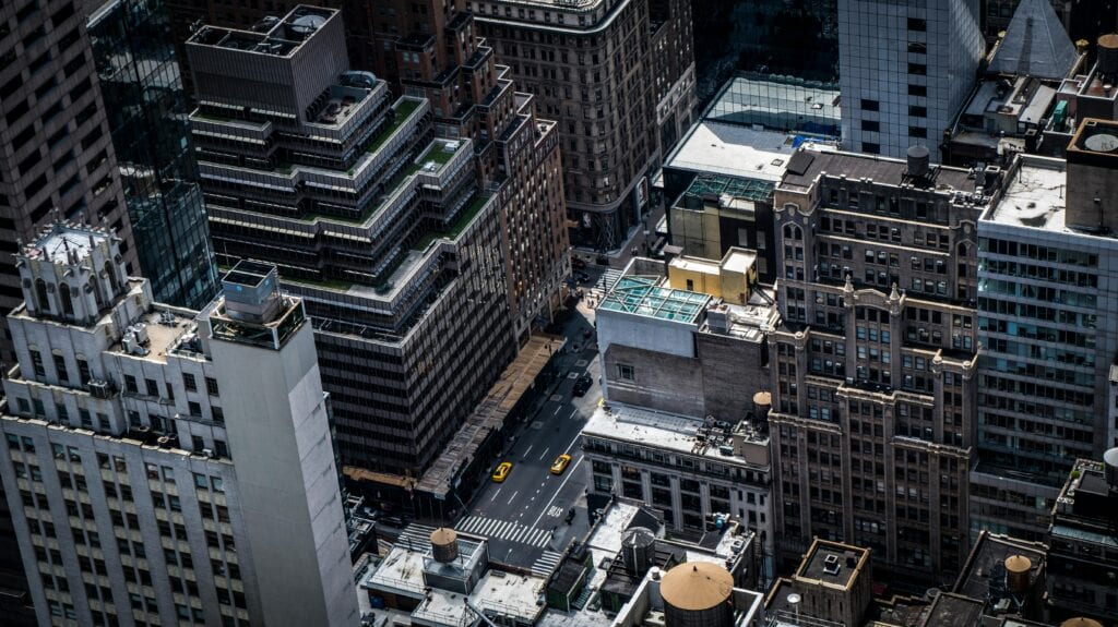Aerial view of skyscrapers and streets in downtown New York City, featuring iconic urban architecture.