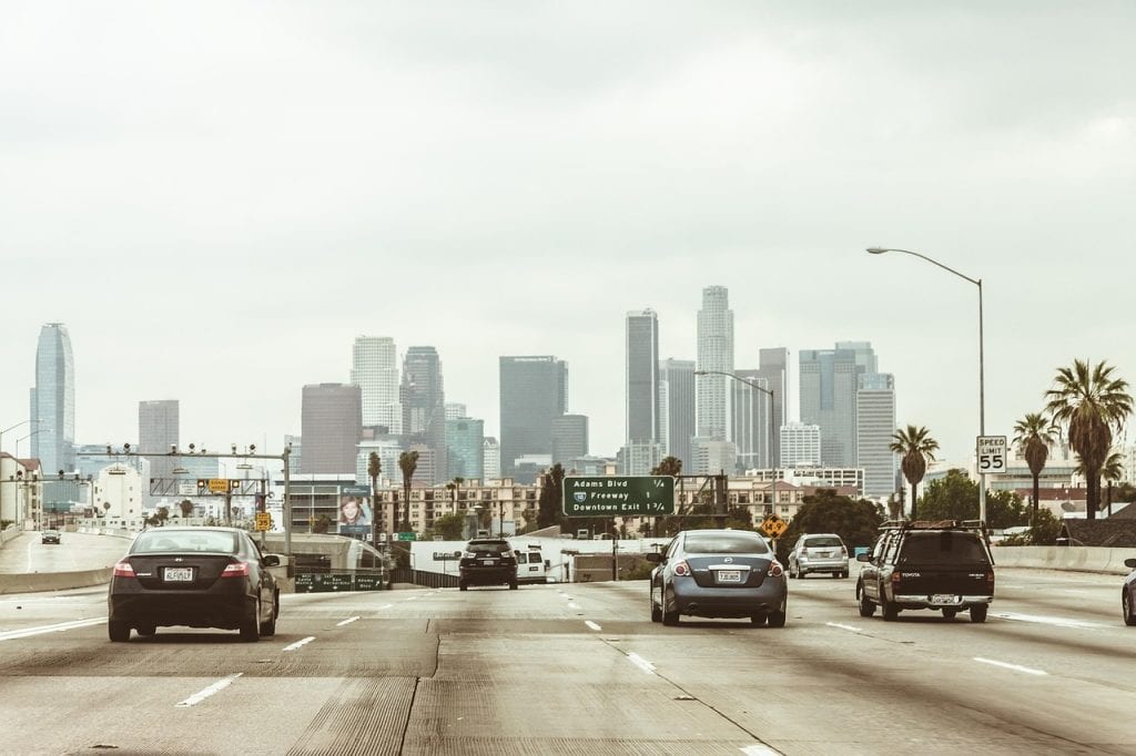 highway, cars, traffic, vehicles, towers, buildings, skyscrapers, los angeles, downtown, nature, center, freeway, office center, city, megalopolis, business centre, architecture, office, high-rise, multistory building, motion, road, asphalt, street, transport, sky, panorama