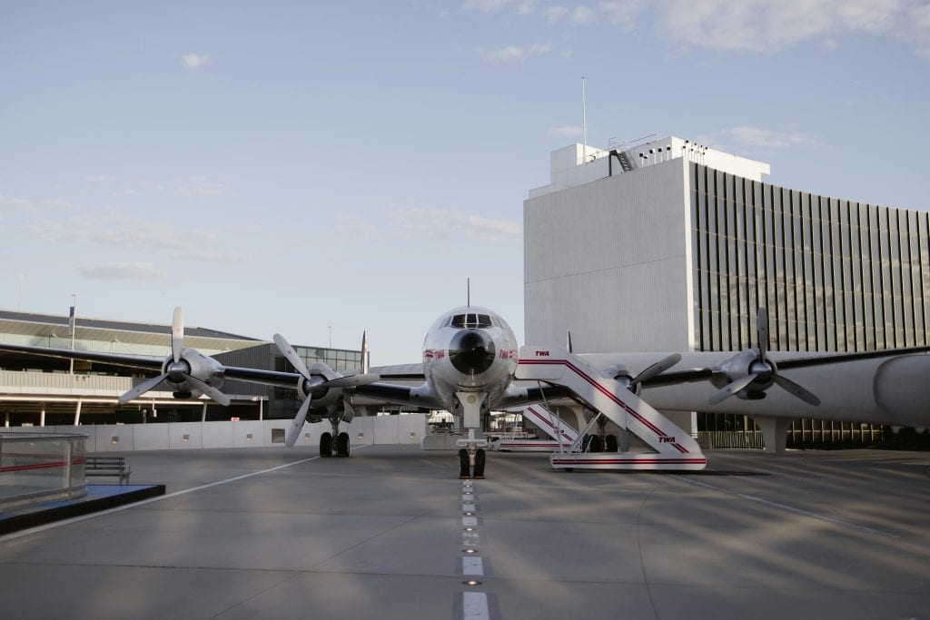Historic aircraft parked at TWA Hotel showcasing classic aviation design in New York City.