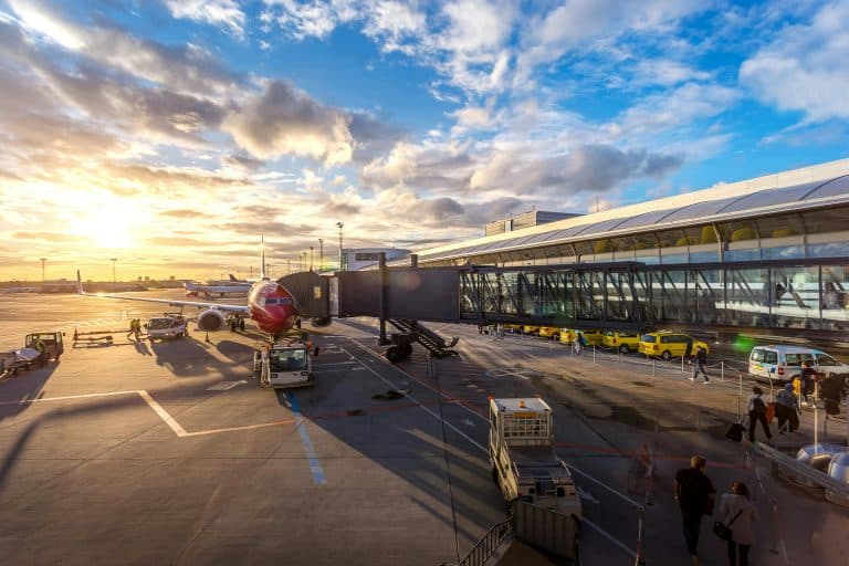 Airport Transfer Blogs | Articles | News | Tips & Tricks | Video | FAQ | Information | Infograph. 22 A vibrant sunset at Copenhagen Airport with airplanes and bustling activity.