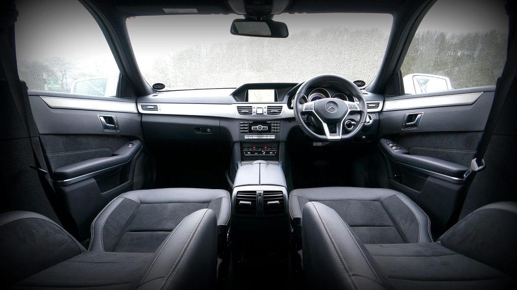 Explore the luxurious interior of a modern car featuring a sleek dashboard and leather seats.