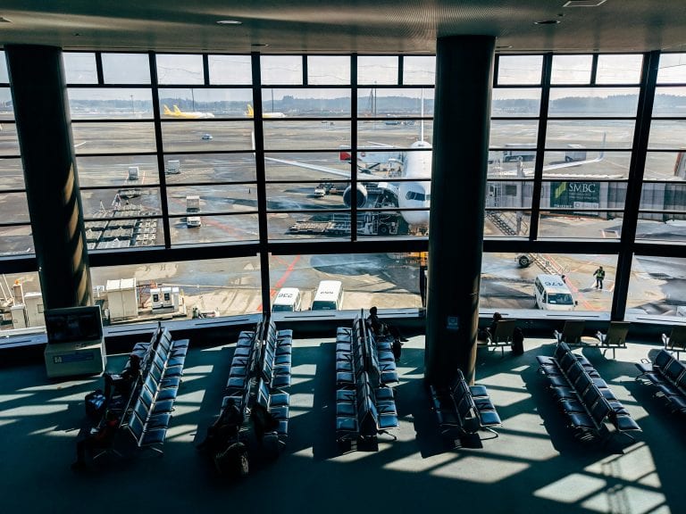 Spacious airport terminal with airplane and tarmac view in Tokyo, Japan.
