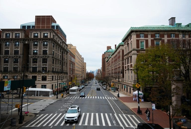 An urban scene showcasing a quiet street in New York City with classic architecture lining both sides.