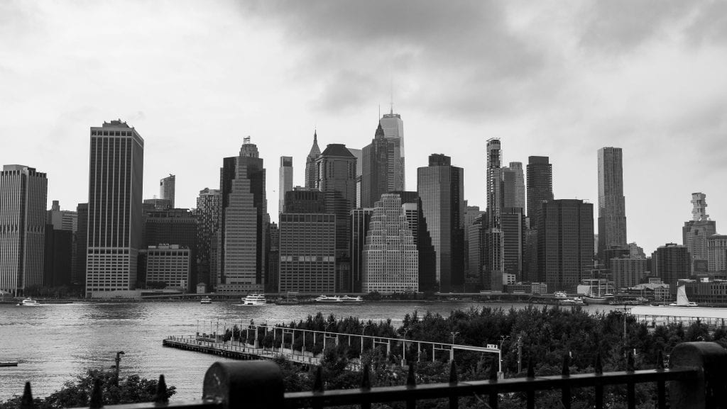 Black and white panorama of New York City skyline from waterfront.