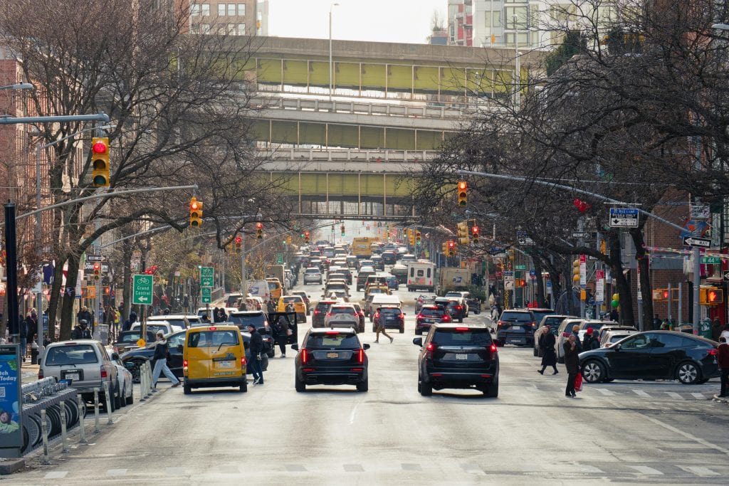 Iconic bustling New York street scene with vehicles and pedestrians in winter.