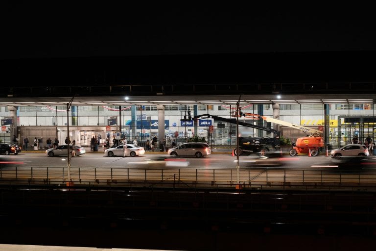 Long exposure captures bustling activity at Chicago O'Hare Airport during nighttime.