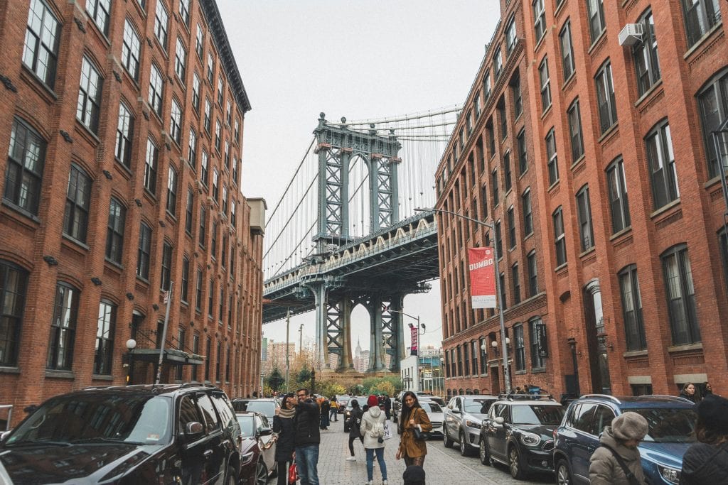 Scenic view of the Manhattan Bridge framed by urban architecture in DUMBO, Brooklyn, NYC.