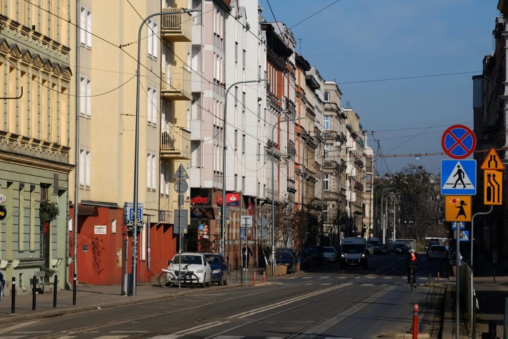 Charming urban street scene showcasing historic European architecture and city life.