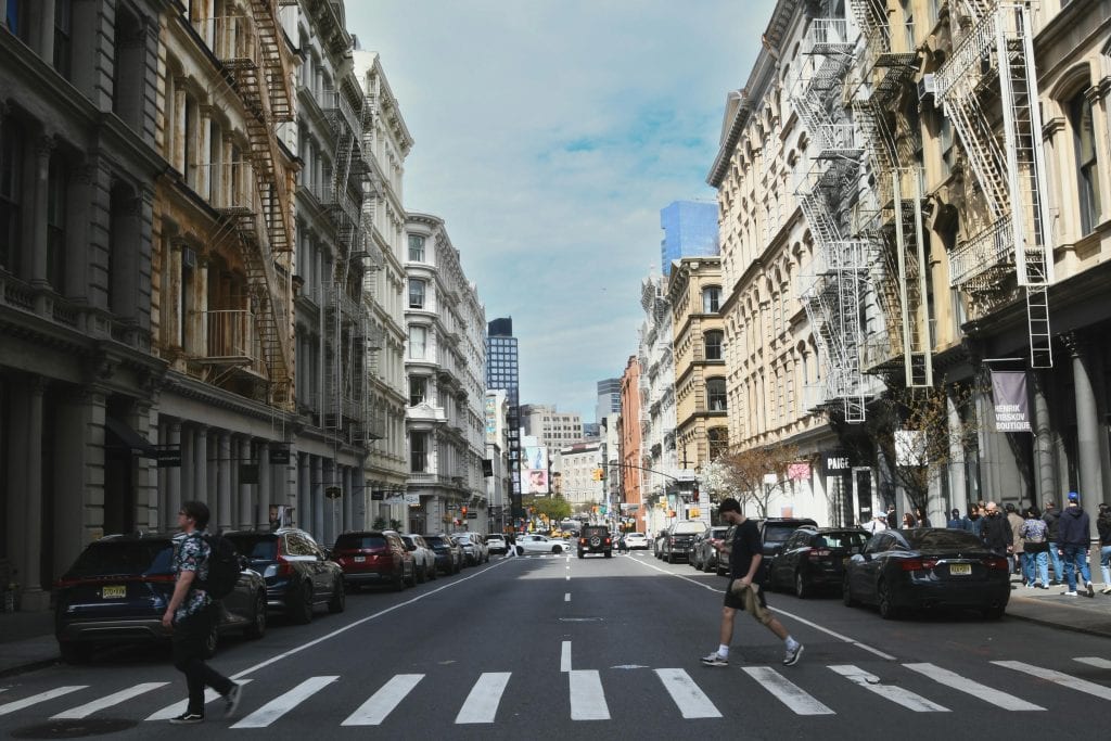 Street view of a busy intersection in Soho, NYC capturing everyday city life.