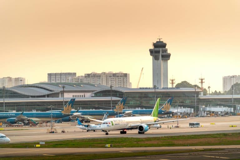 Airport Transfer Blogs | Articles | News | Tips & Tricks | Video | FAQ | Information | Infograph. 29 Airplanes parked on a runway under a dramatic golden sunset sky at a modern airport terminal.
