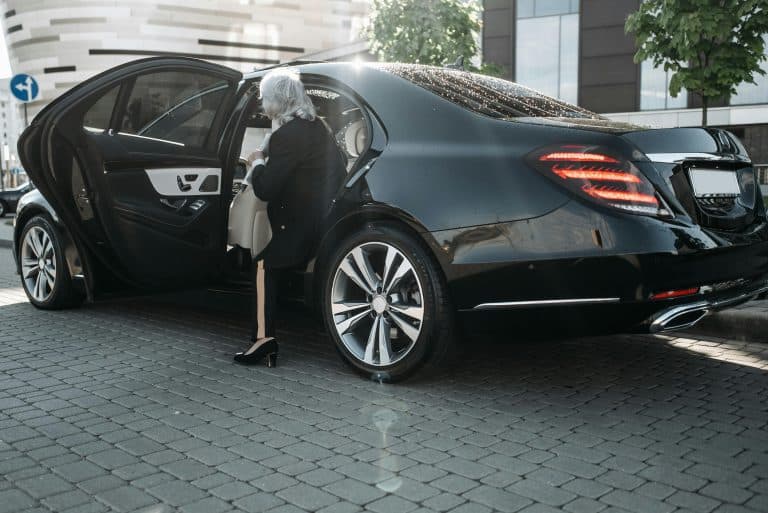 Places & Attractions Blogs | Articles | News | Tips & Tricks | Video | FAQ | Information | Infograph. 35 Senior businesswoman stepping out of a sleek black luxury vehicle in a cityscape.