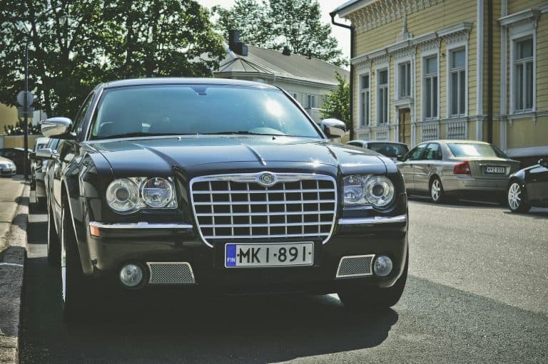 Car Service Blogs | Articles | News | Tips & Tricks | Video | FAQ | Information | Infograph. 24 A sleek black car parked on a sunny street in Hamina, Finland, showcasing luxury and elegance.