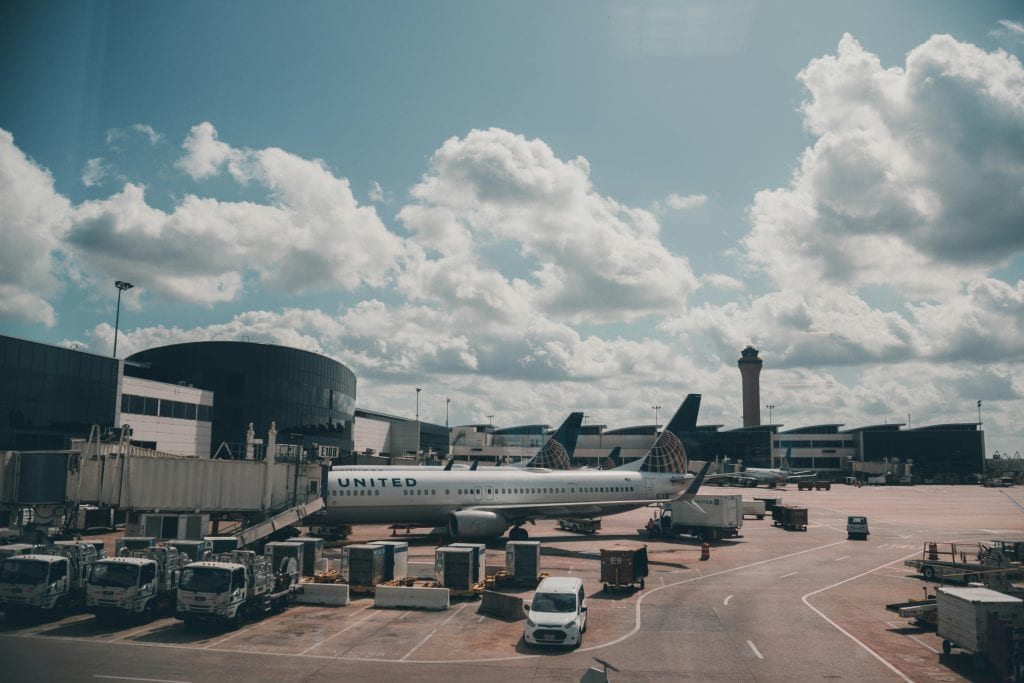 eco friendly airport pickup JFK electric vehicle black car at JFK arrivals terminal