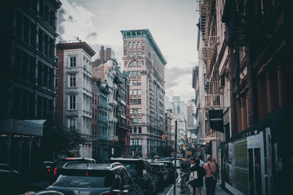 Urban scene capturing traffic and pedestrians in historic Soho, NYC.