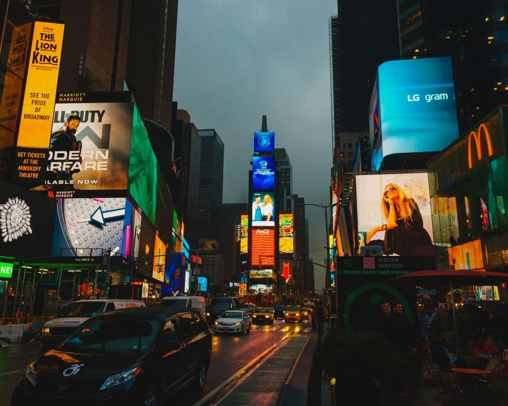 Bright lights and billboards in Times Square, capturing the bustling evening atmosphere.