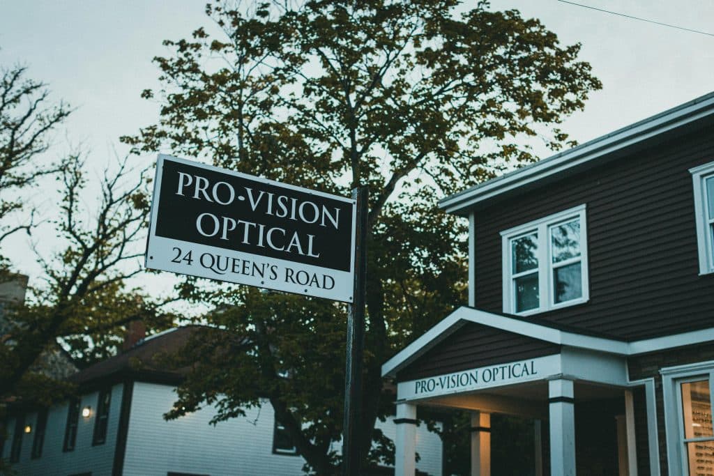 Street view of Pro-Vision Optical signage and storefront, showcasing local business atmosphere.