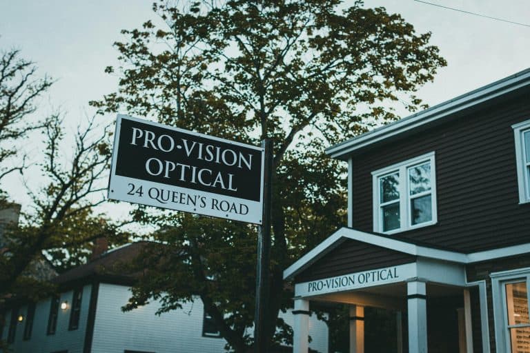 Street view of Pro-Vision Optical signage and storefront, showcasing local business atmosphere.