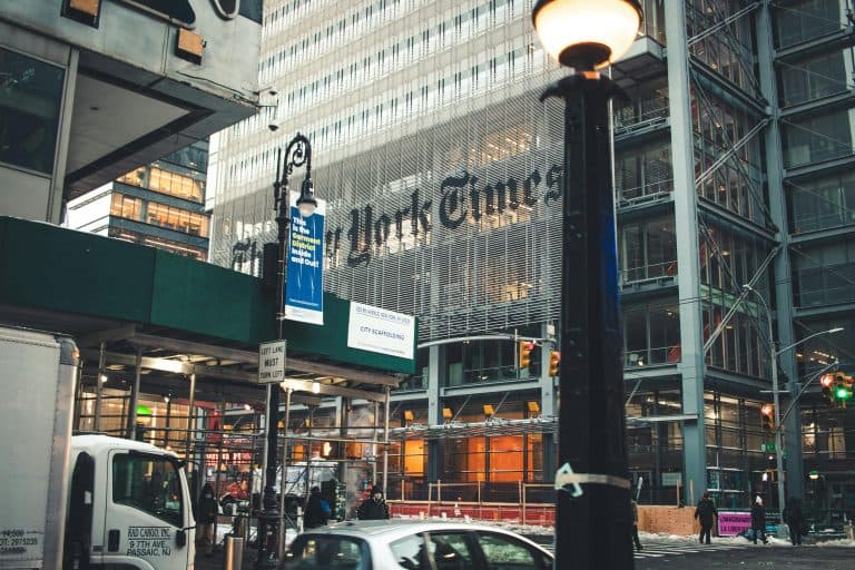 Places & Attractions Blogs | Articles | News | Tips & Tricks | Video | FAQ | Information | Infograph. 10 Street view of the New York Times Building in Manhattan with bustling city life and vehicles.