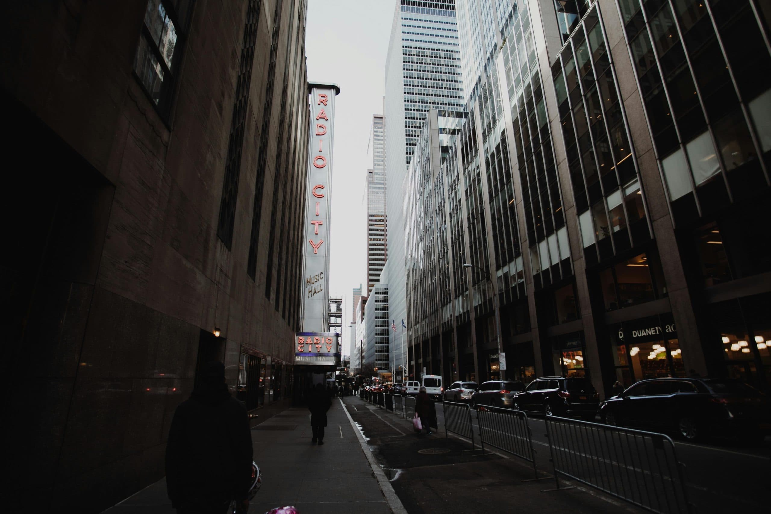 Iconic view of Radio City Music Hall surrounded by skyscrapers in NYC.