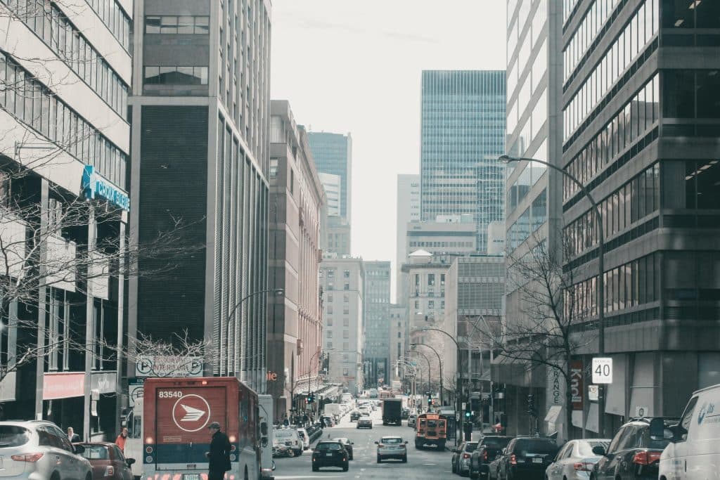 Lively street scene in downtown Montreal, showcasing urban architecture and bustling traffic.