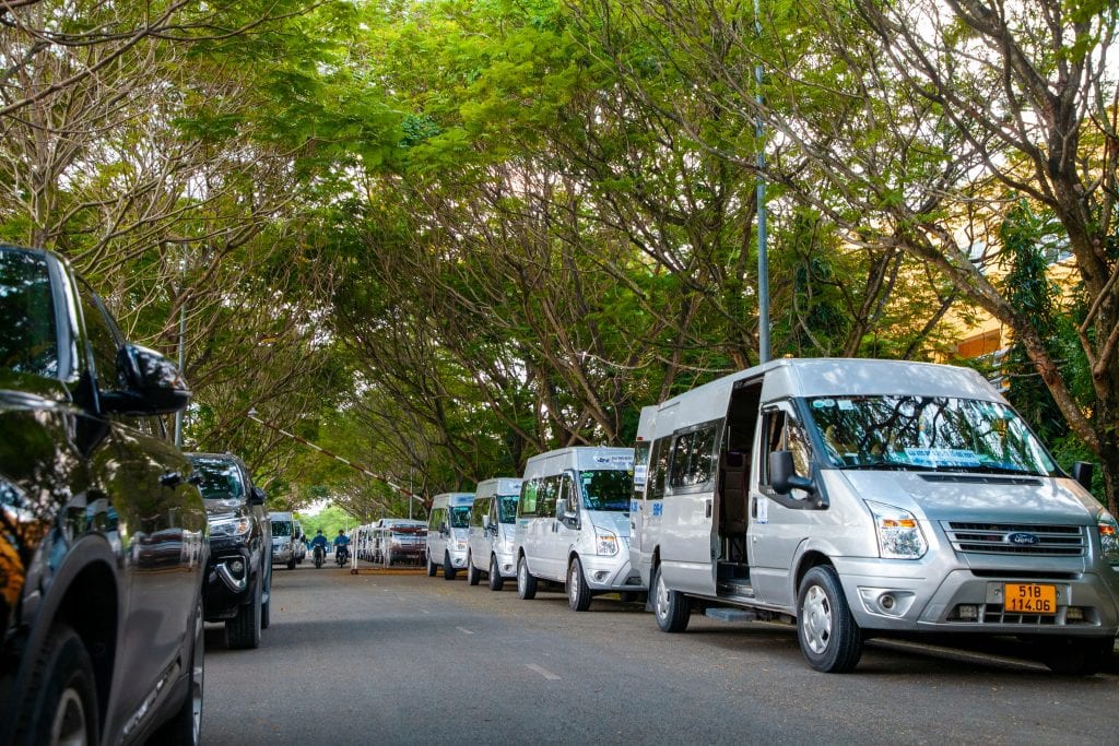 Luxury Limo Service from LaGuardia: Your 2026 Survival Guide to Stress-Free Manhattan Arrivals 9 City street scene with parked vehicles beneath a lush green canopy, showcasing urban life in summer.