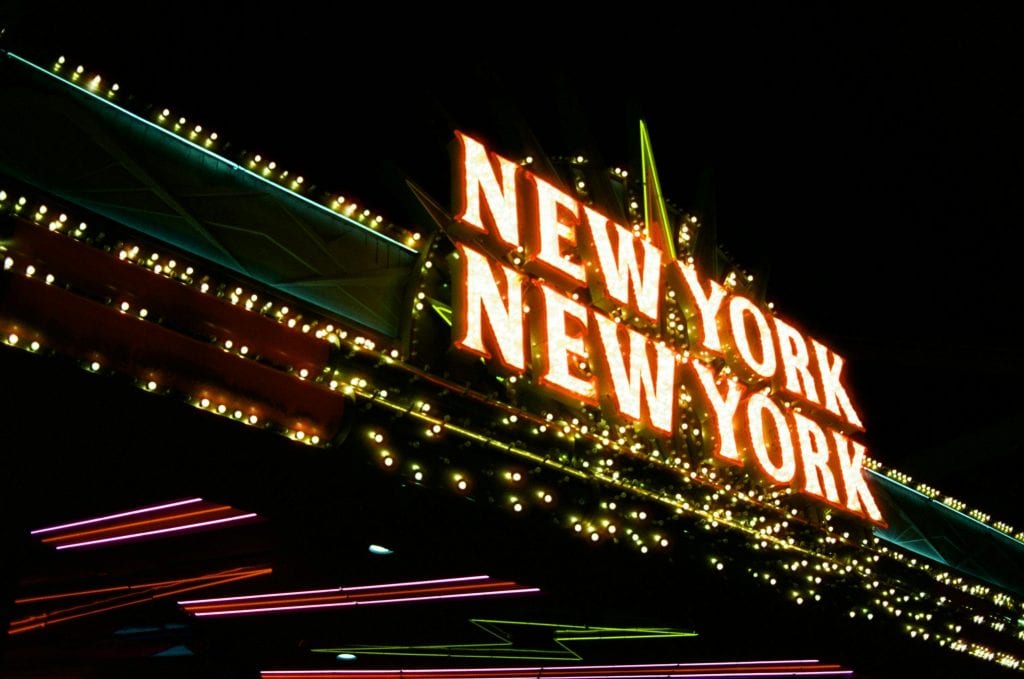 Luxury Town Car Service New York City: 6 Honest Facts for 2026 9 Bright neon lights of the New York New York sign glowing at night in vibrant colors.