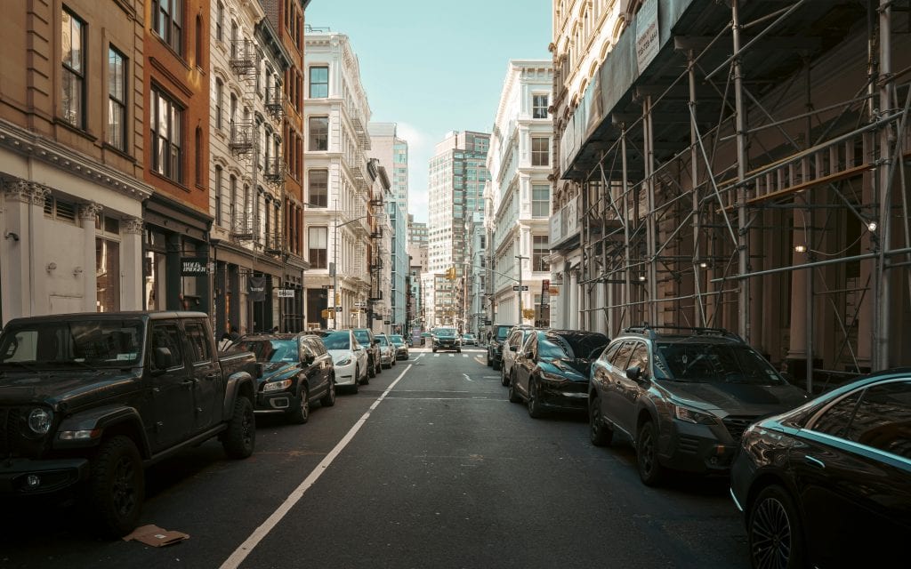 Car Service NYC to JFK Reviews 2026: 5 Proven Facts for Business Travelers 3 A bustling street in New York City with classic architecture and a variety of parked cars.