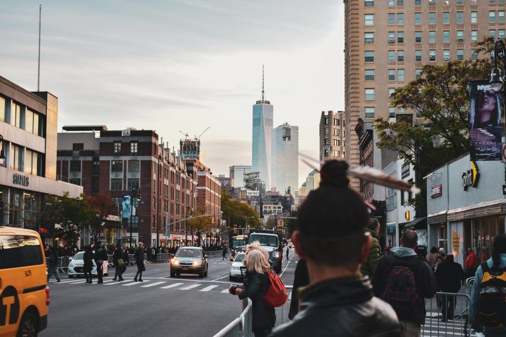 Luxury Cheap Car Service to LaGuardia: 7 Proven Facts Families Need in 2026 17 Vibrant street scene in NYC featuring One World Trade Center at sunset.
