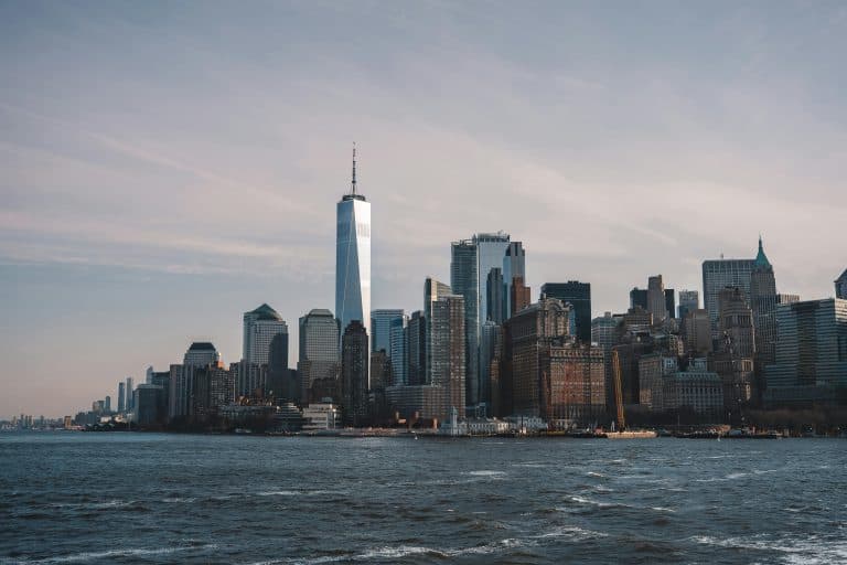 Picturesque view of the NYC skyline with One World Trade Center at sunset.