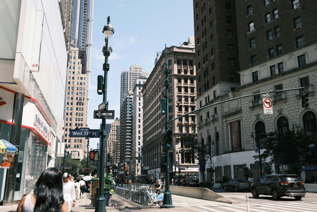 A vibrant view of West 33rd Street in New York City showcasing urban life and architecture.